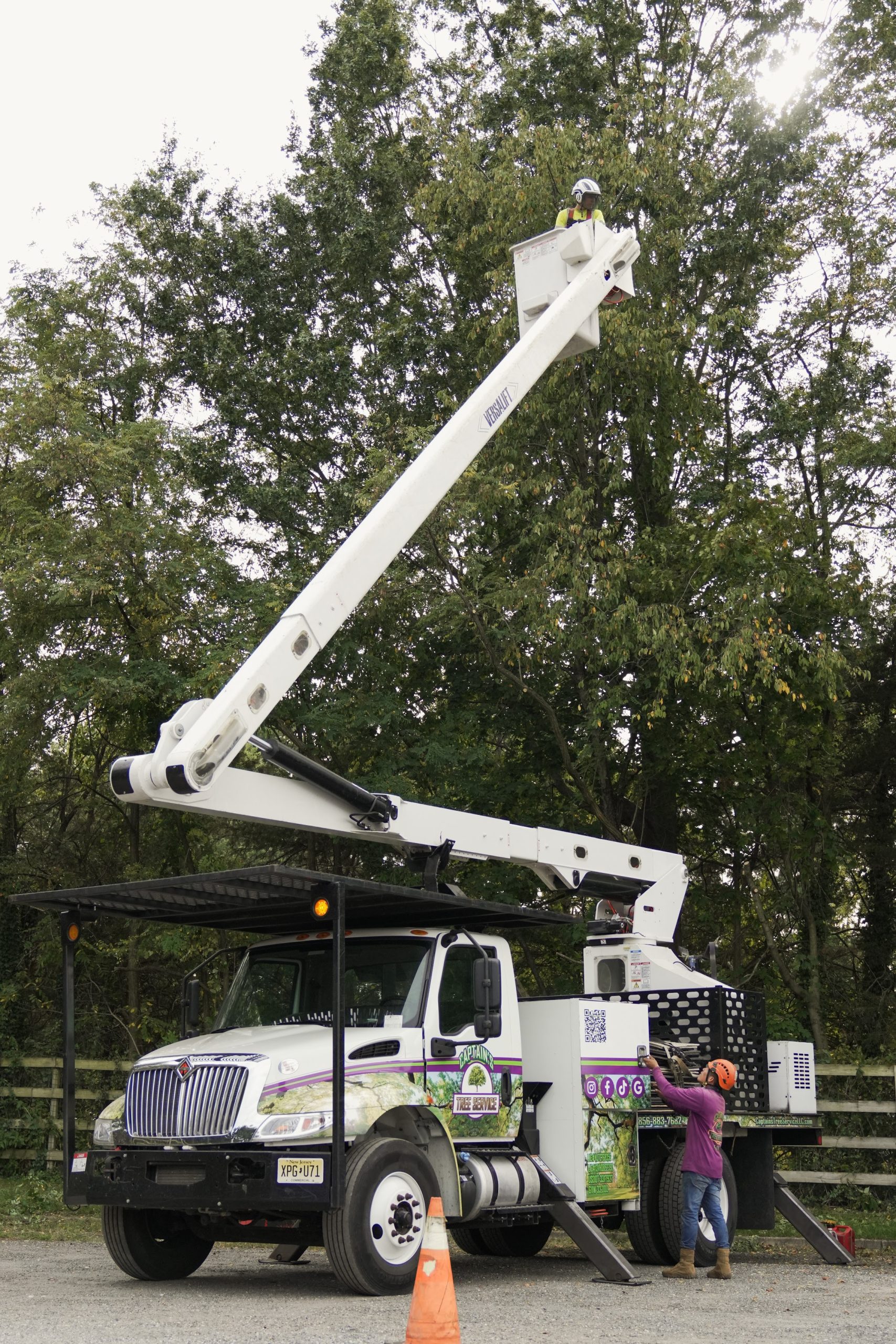 Captain's Tree Service crew using a bucket truck for professional tree service in Mays Landing NJ